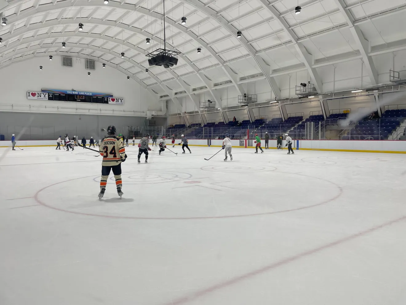 Hockey teams compete in a pickup game at an indoor rink.