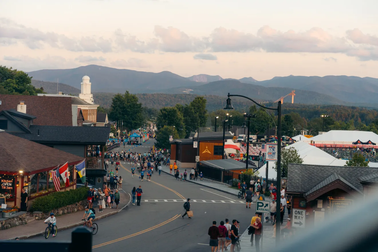 A downtown in the evening during a race event. 