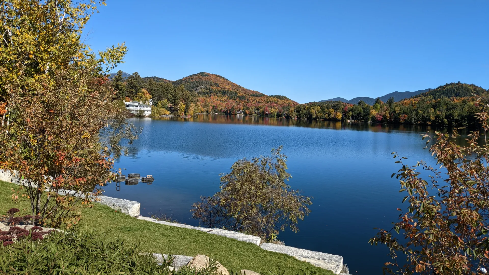 A view of Mirror Lake with mountains and trees in the backdrop