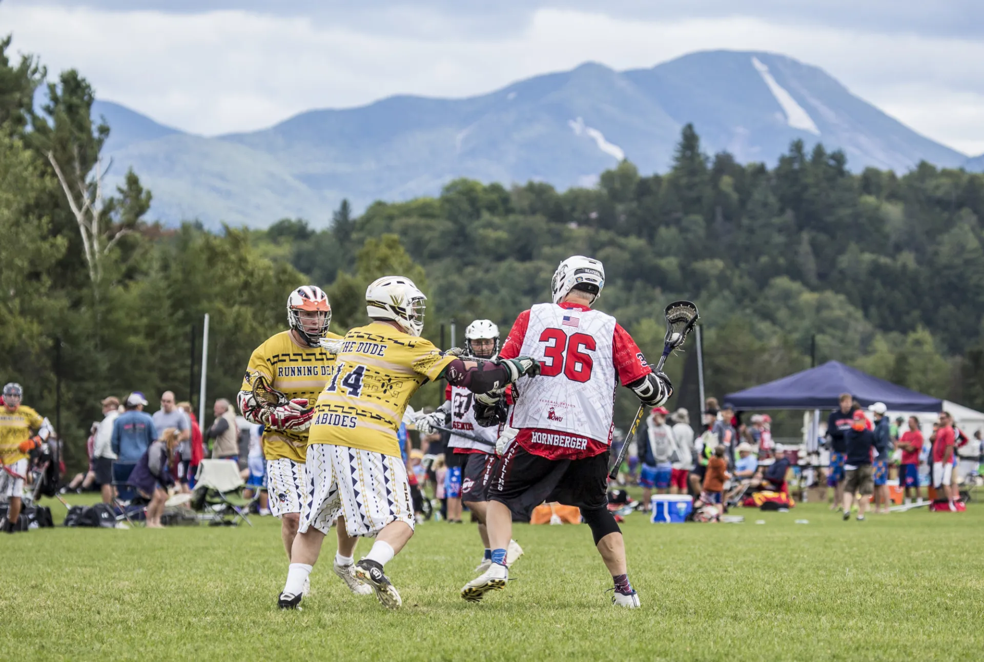 lacrosse players try to get the ball in front of High Peaks.