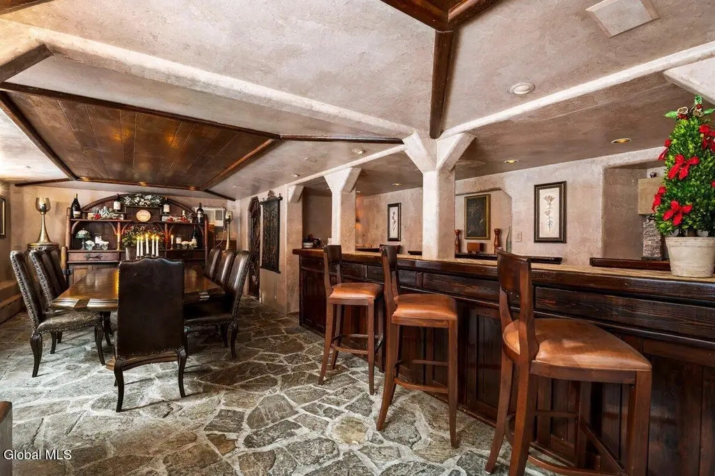 The private dining room with bar area and large table with plush leather chairs.