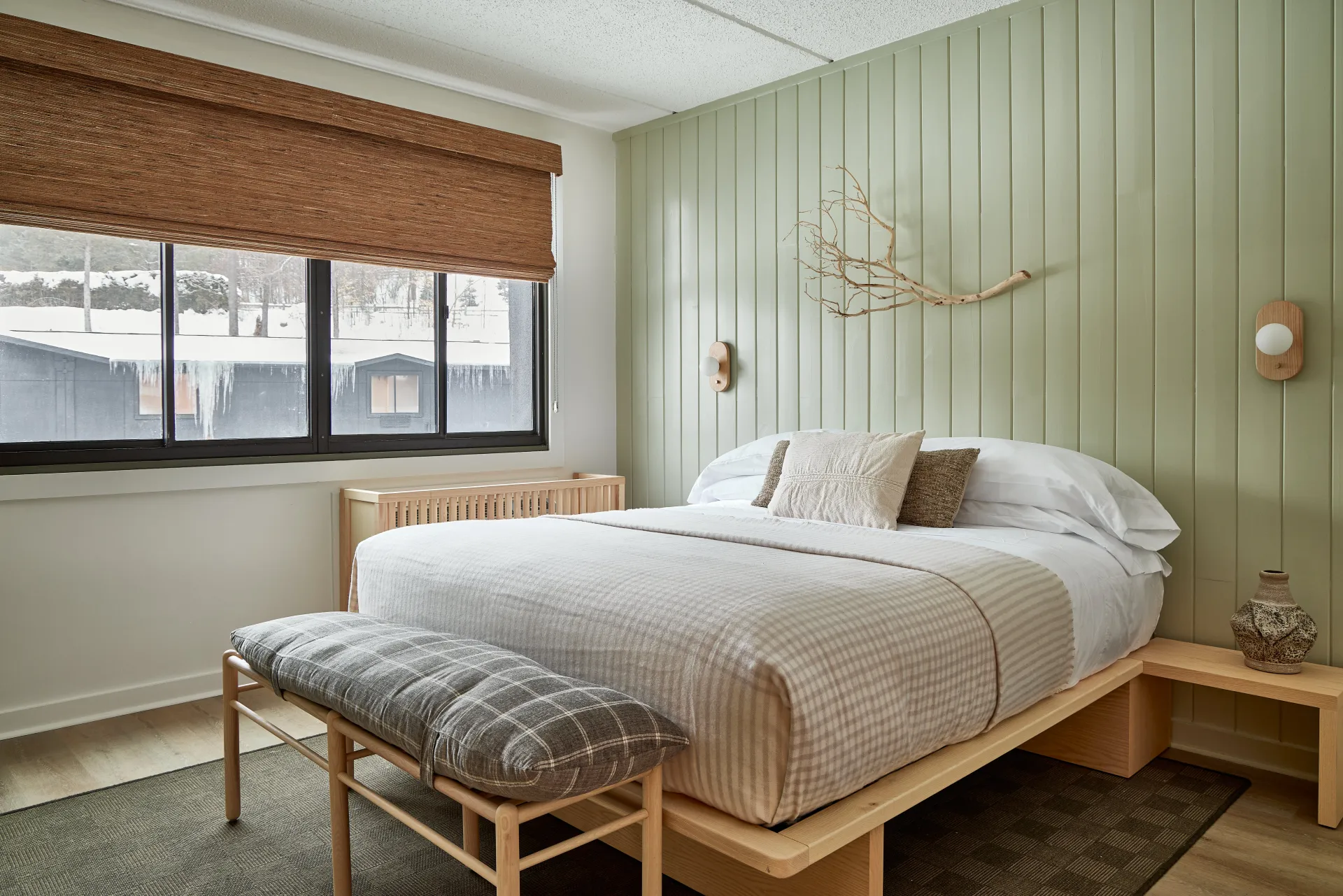 One king bed in a mint colored room.