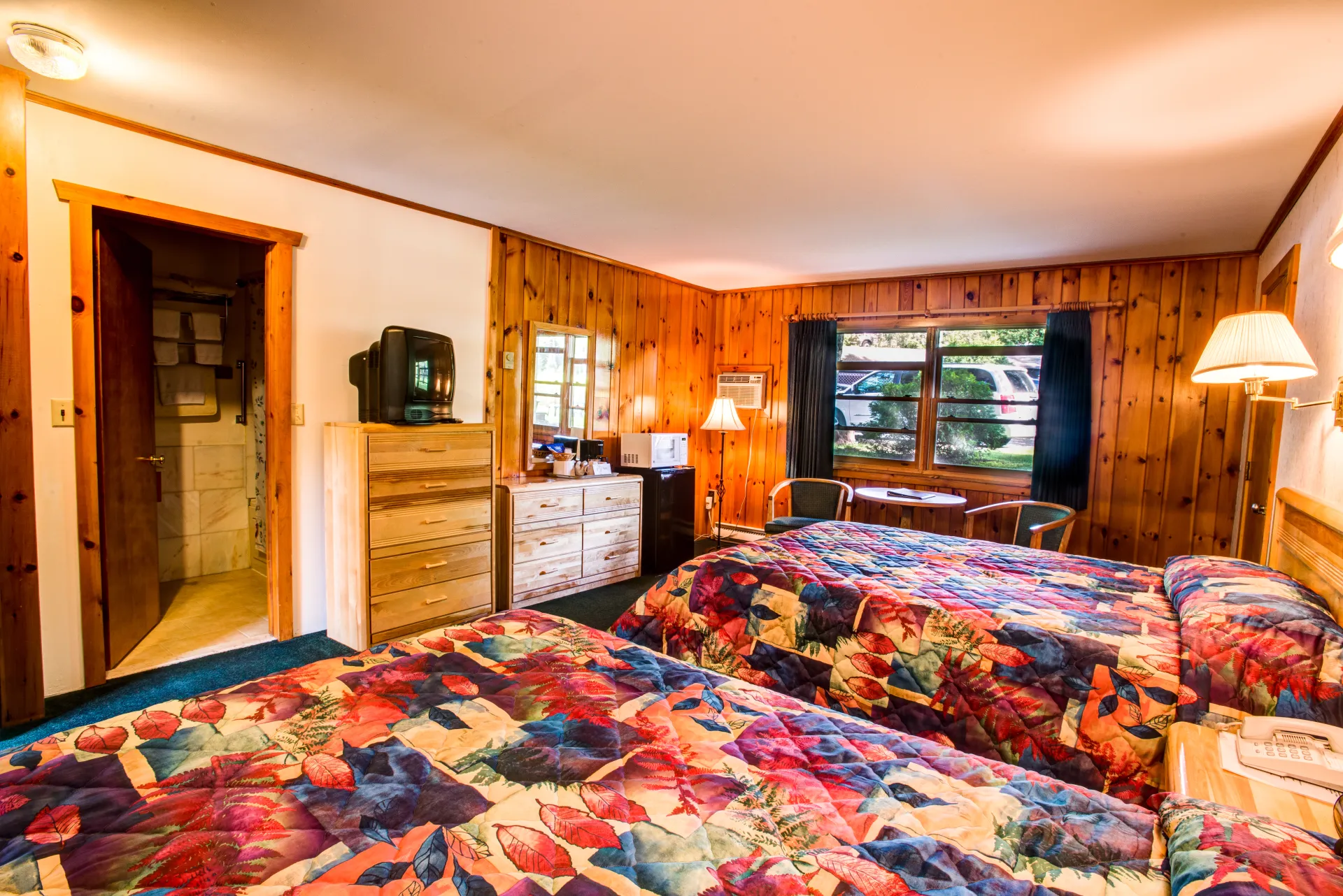 Colorful bedding in a two queen room.