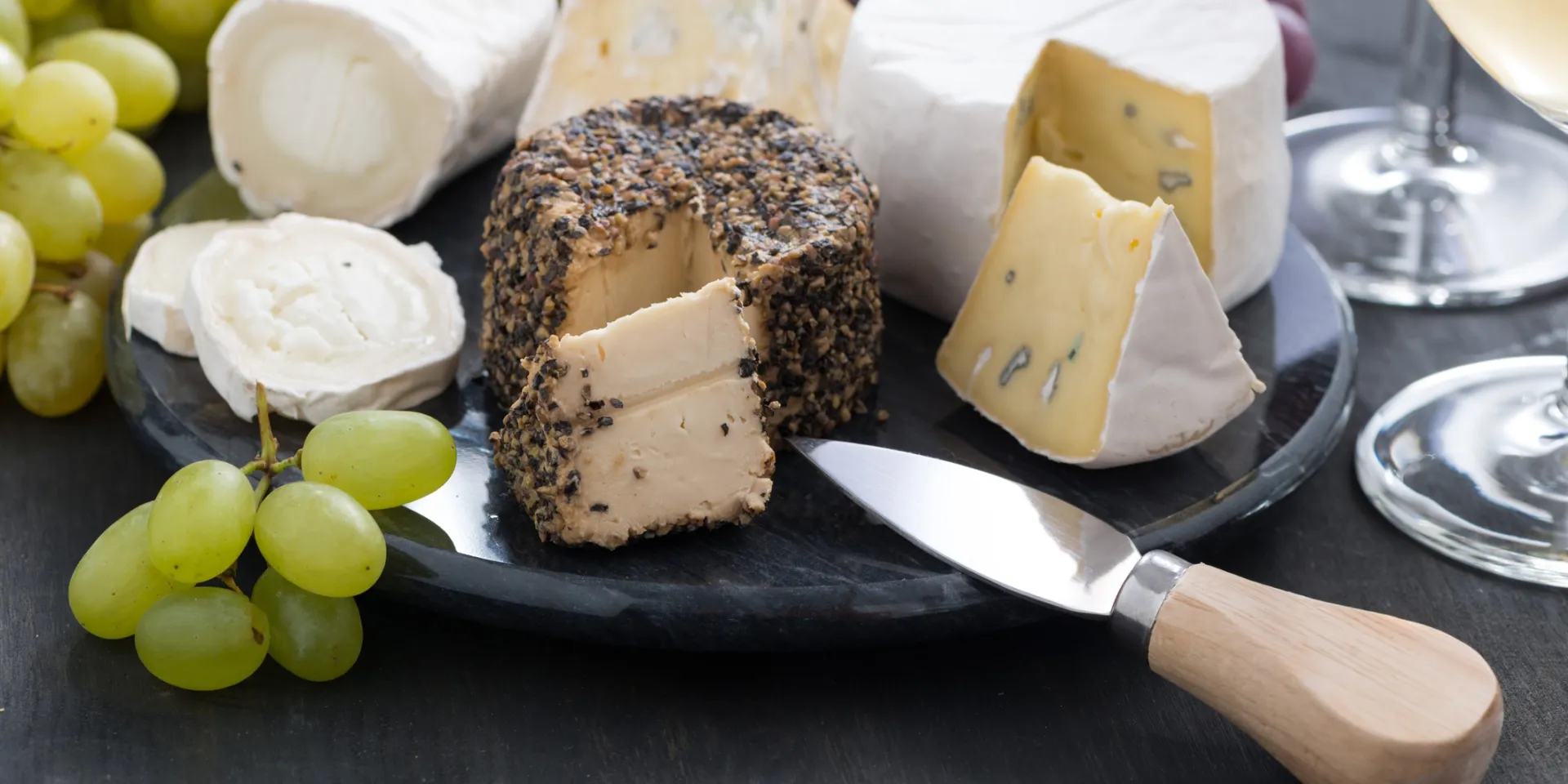 A board featuring assorted cheeses.