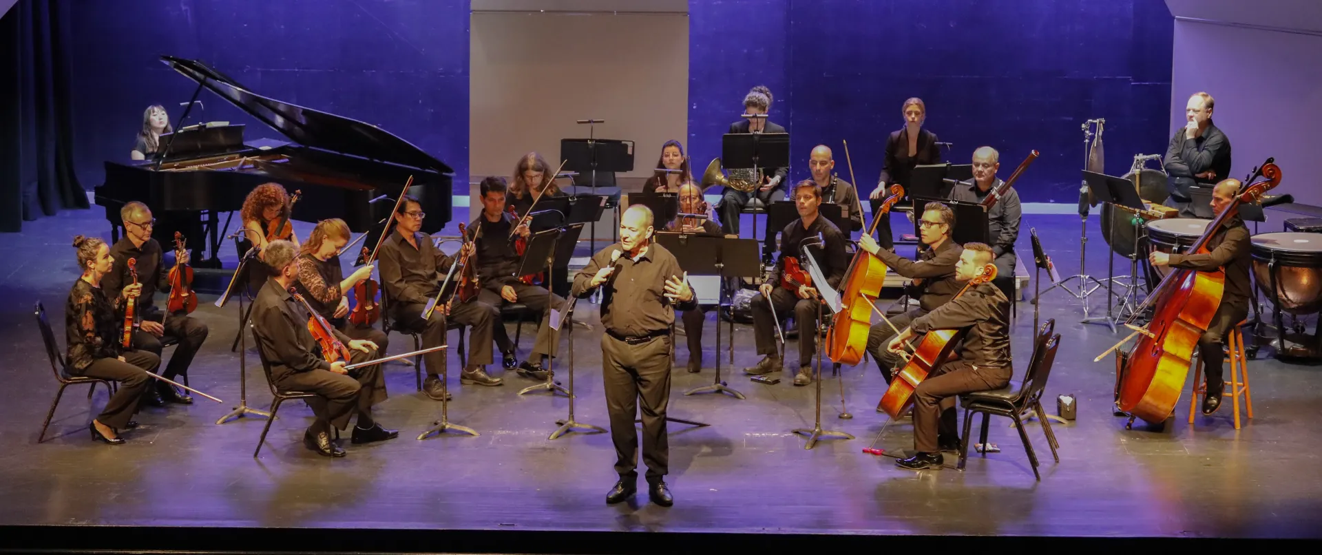 Orchestra on Stage, Conductor addressing crowd Credit to: Lohr McKinstry