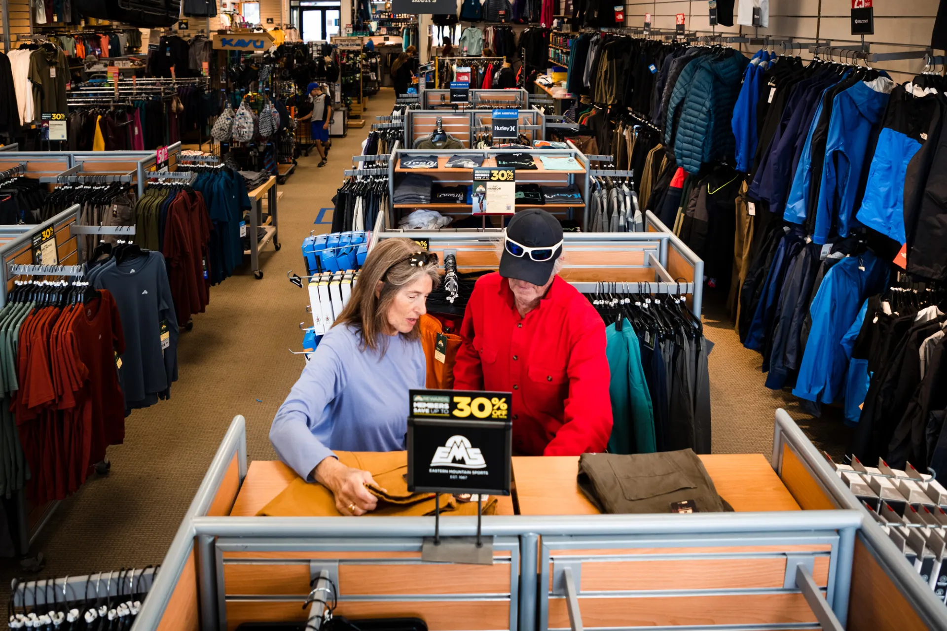 Two people standing at a front register of an outdoor clothing store in Lake Placid.