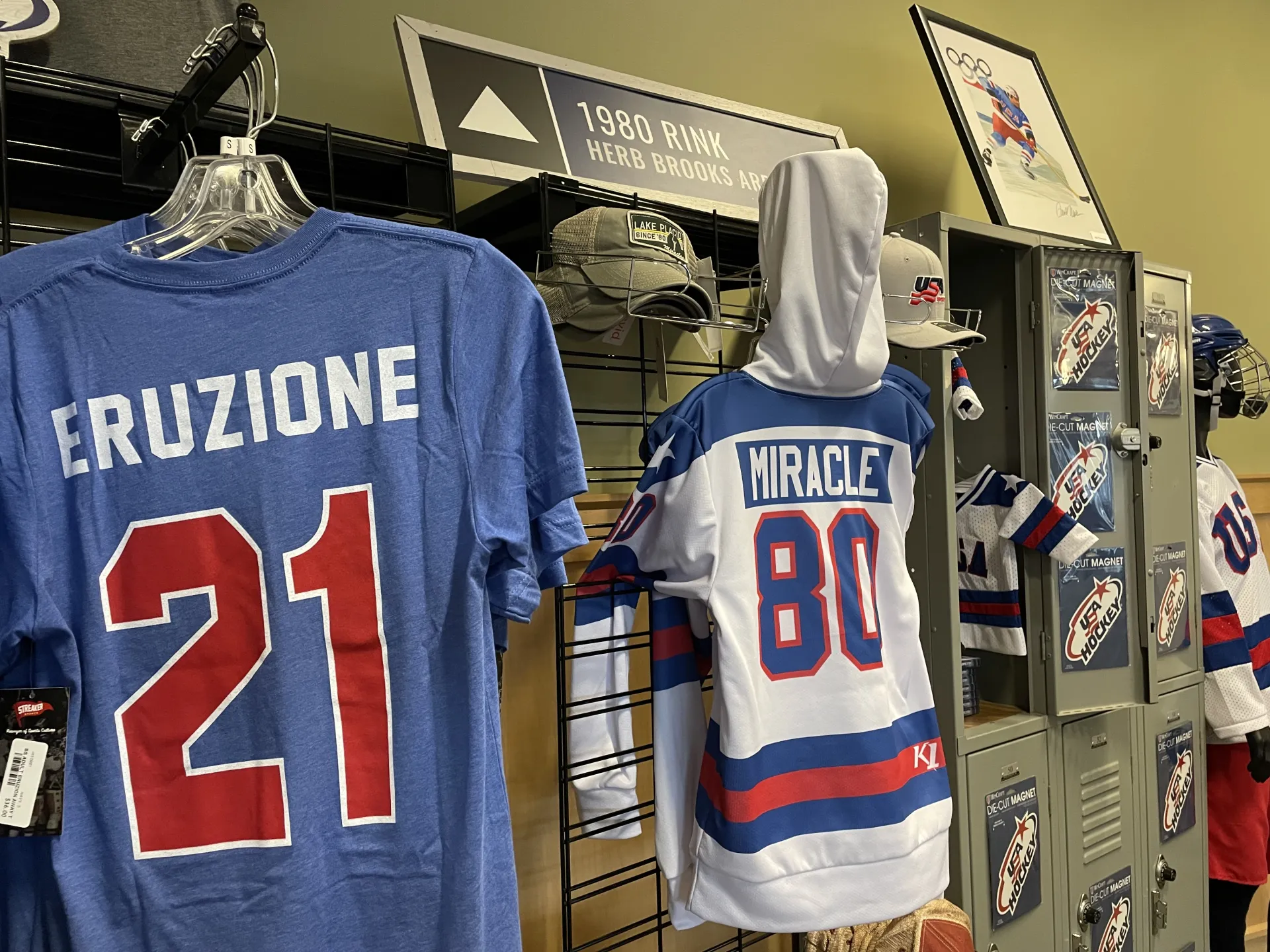 A display of tshirts, jerseys, and other hockey apparel and memorabilia in a shop.
