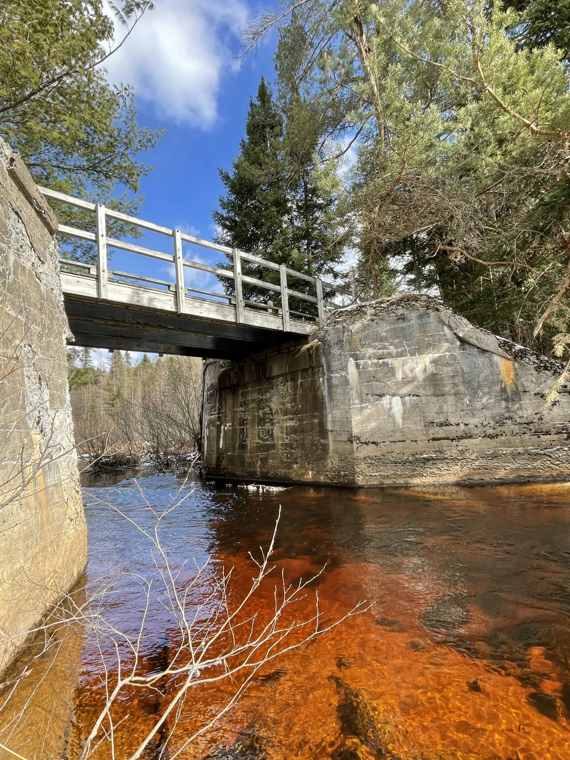 Photo of John Thomas Brook with stone walls and bridge over water