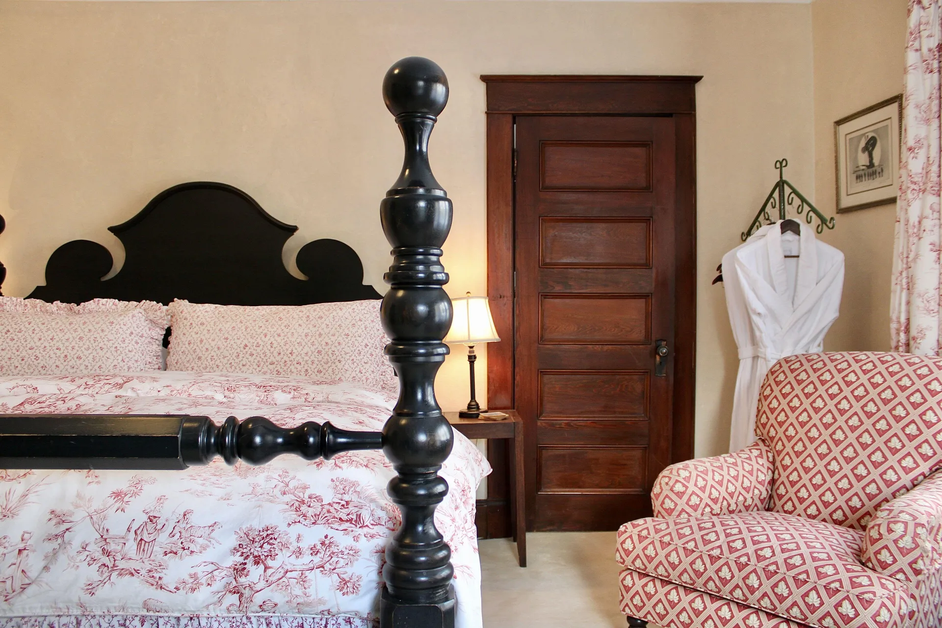 A plush guest room with dark wooden bed.