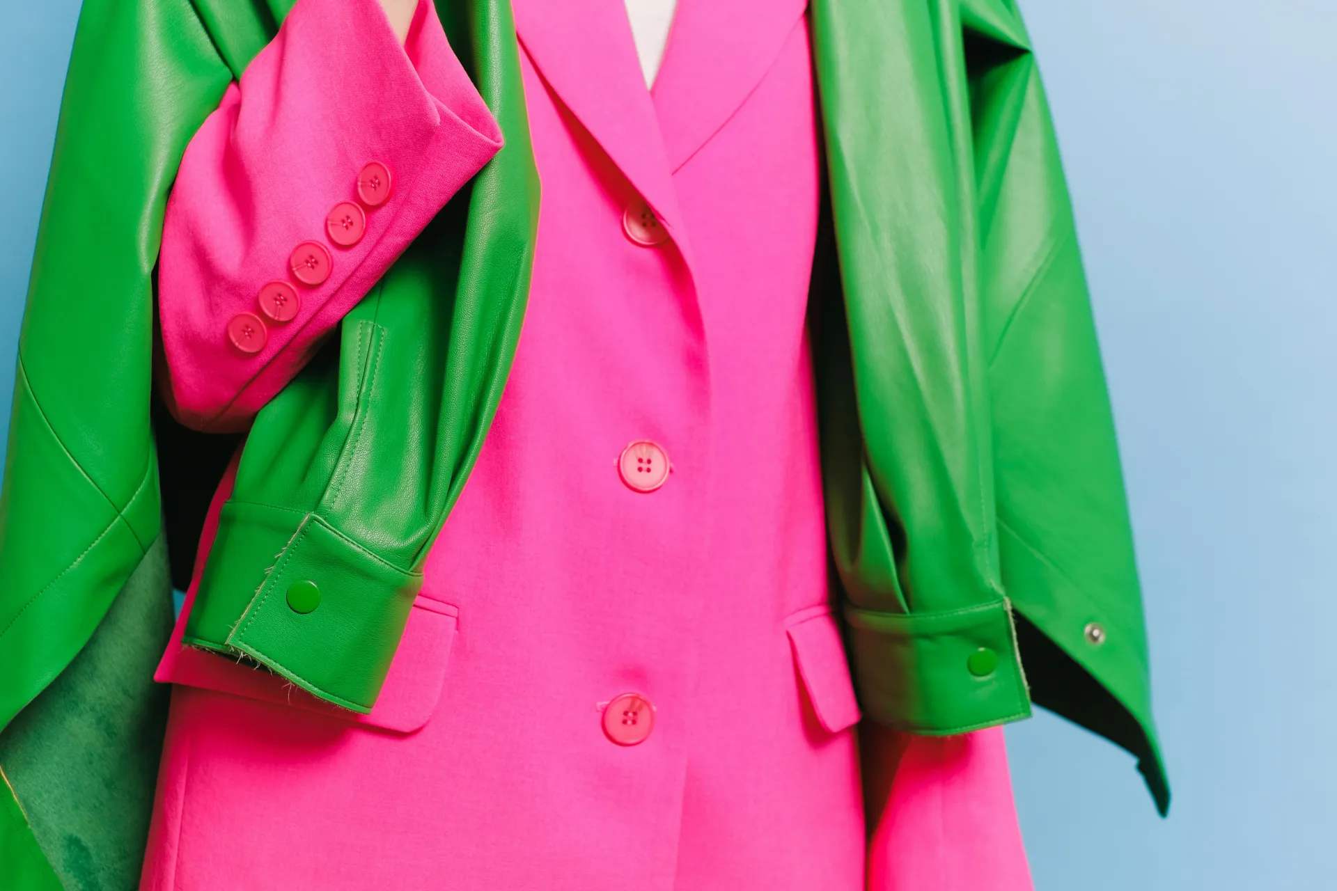 stock image of hot pink blazer on mannequin with bright green jacket overlaid