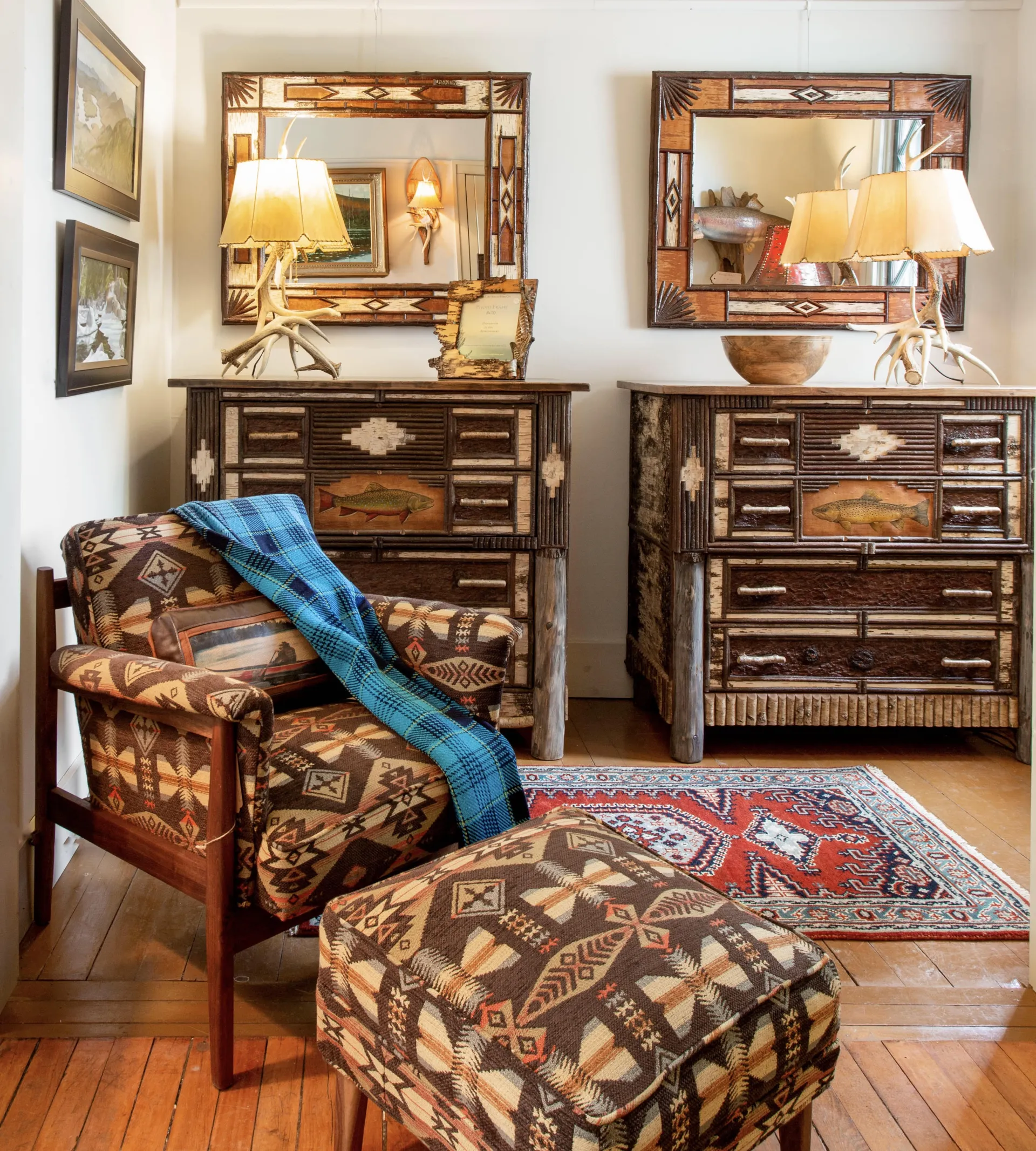 A matching set of birch dressers emblazoned with brook trout.  Birch bark mirrors hang above and the look is completed with matching set of table lamps crafted from antlers.