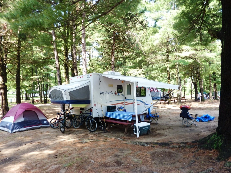 An RV fully set up in one of the spots at Ausable Chasm Camping.