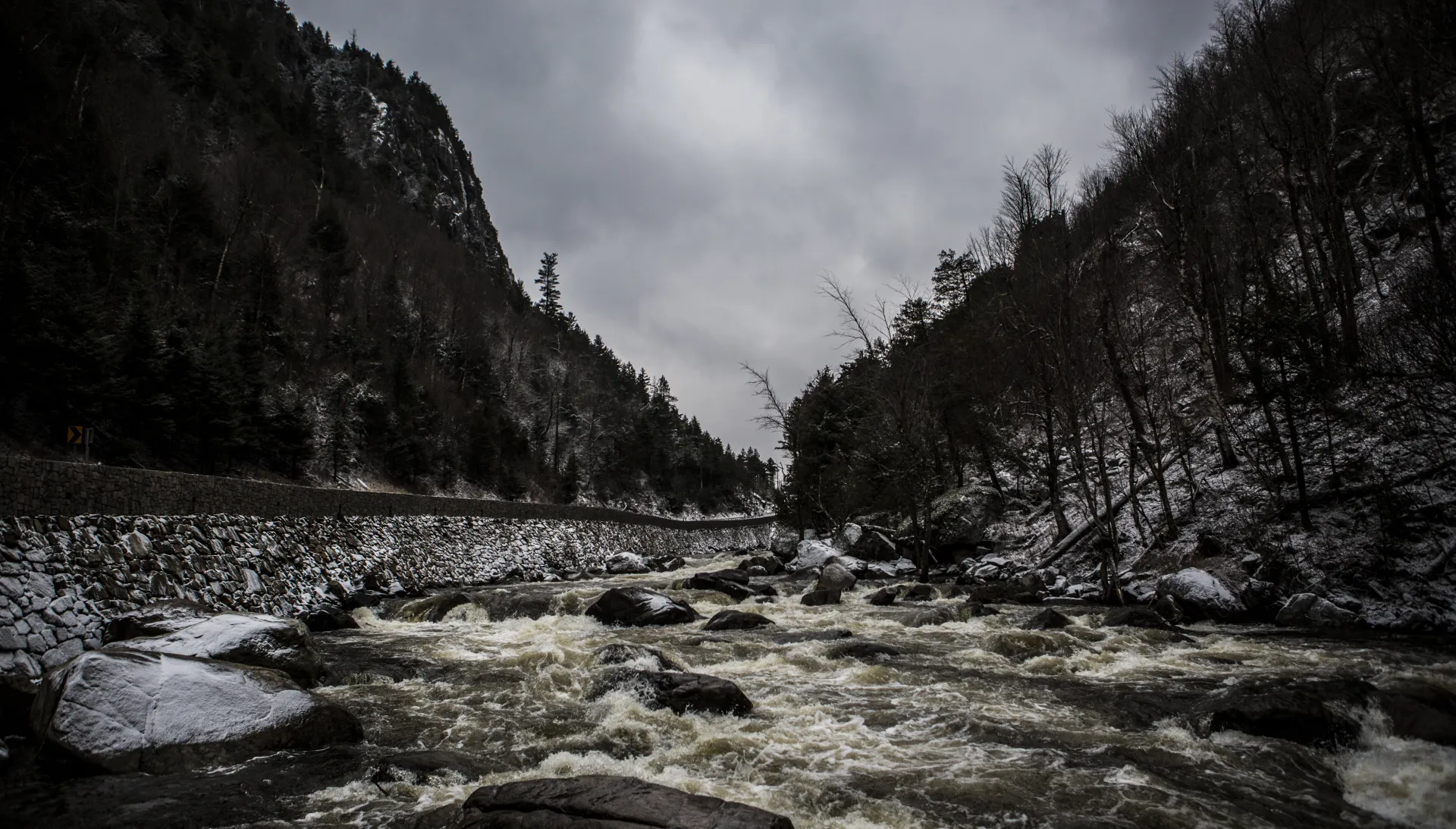 A shallow rock river through a mountain pass