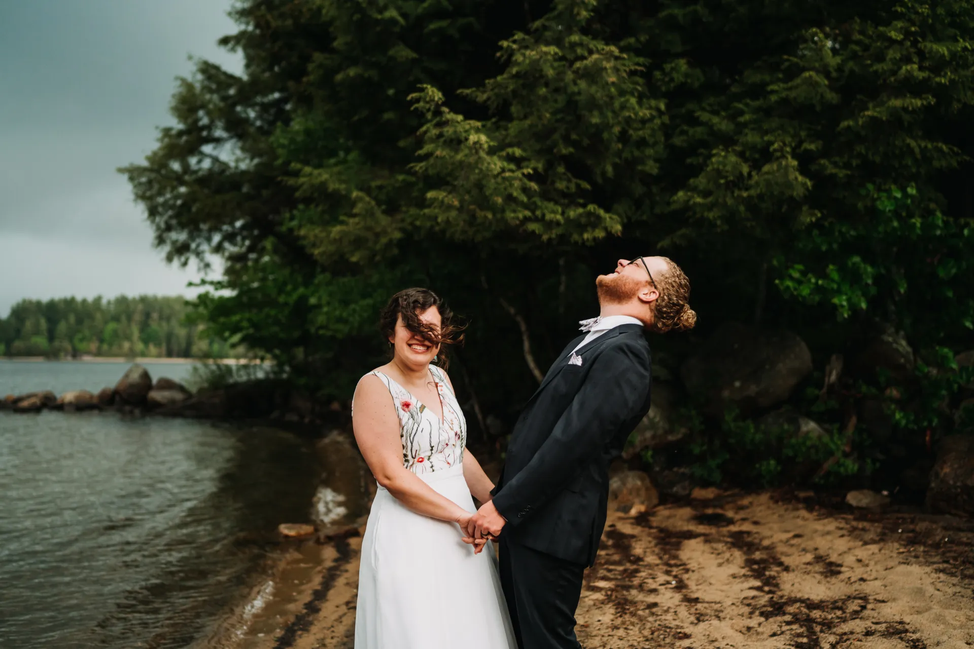 married couple laughing by the beach