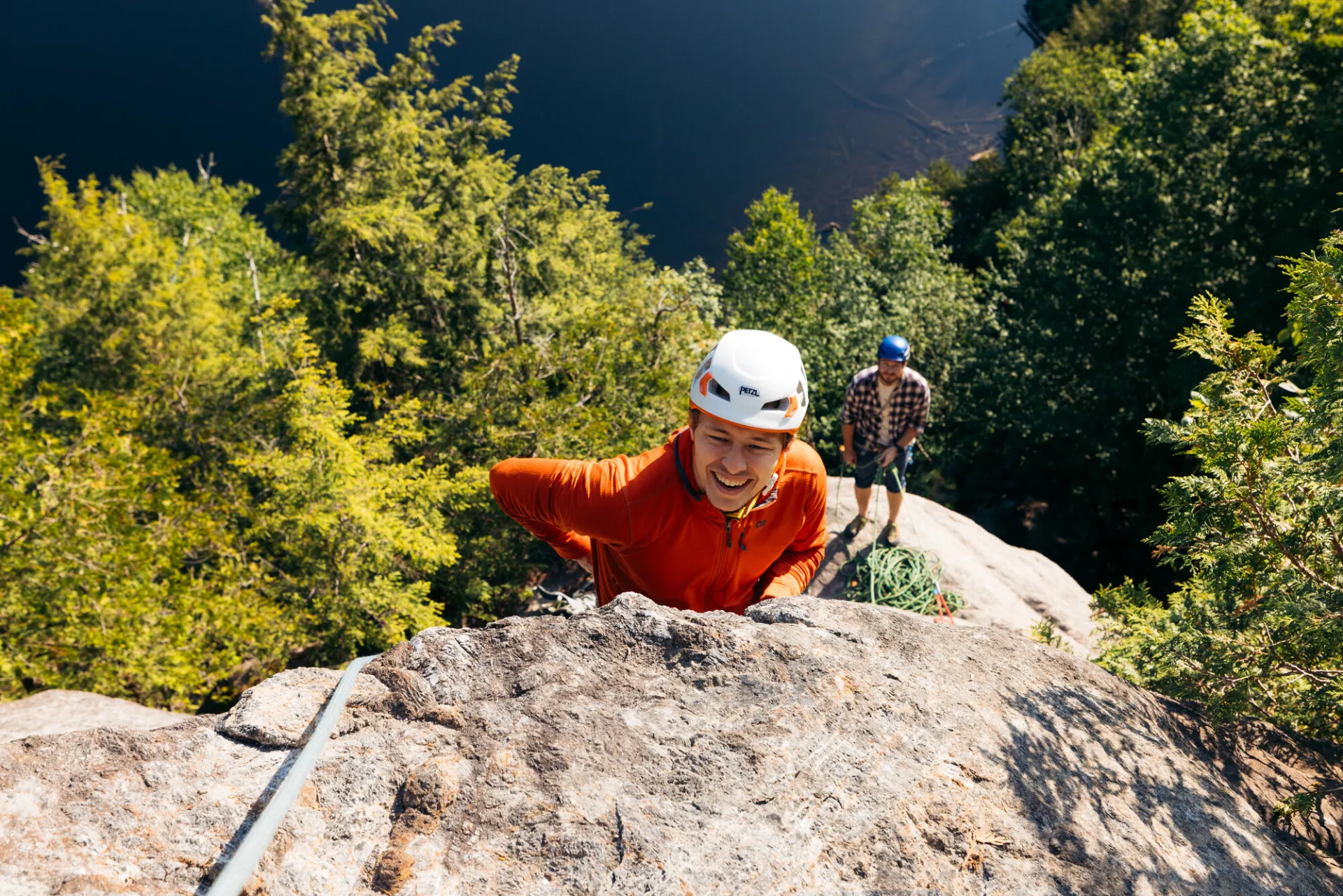 A rock climber ascends a blunt arete