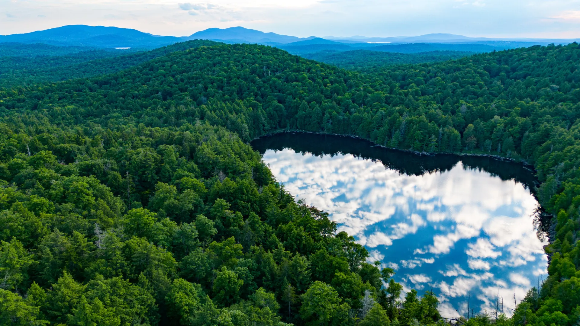 Clouds reflect in an Adirondack Pond