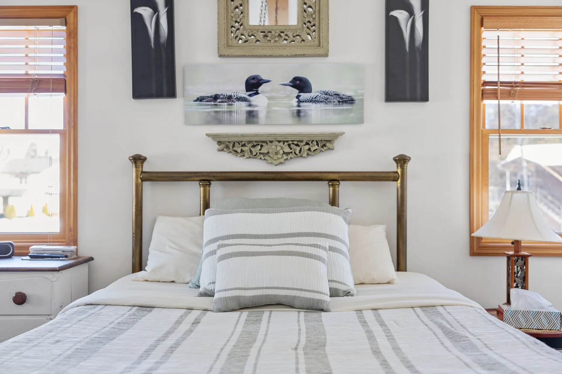 A lush bed with loon images on the lower level at Lake Placid Pinehill Townhouse.
