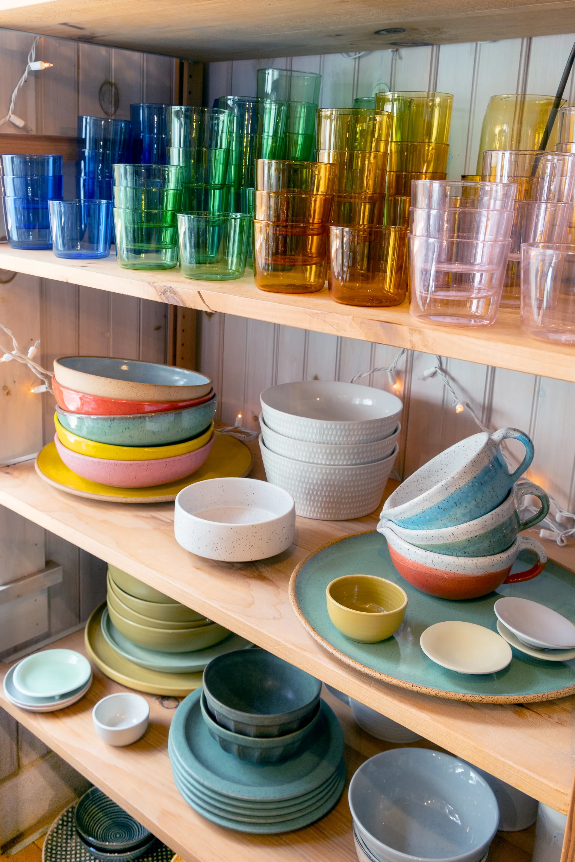 Kitchen decor with colorful glasses, bowls and cups.