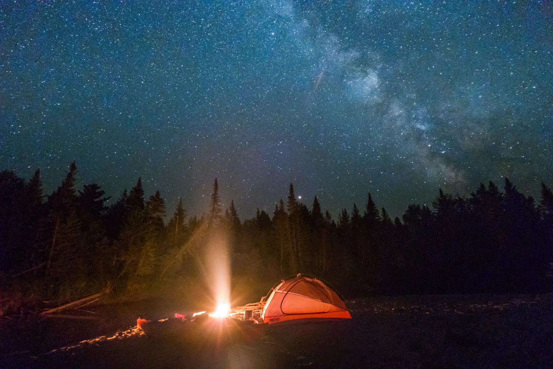 Camping under the stars with a tent and fire