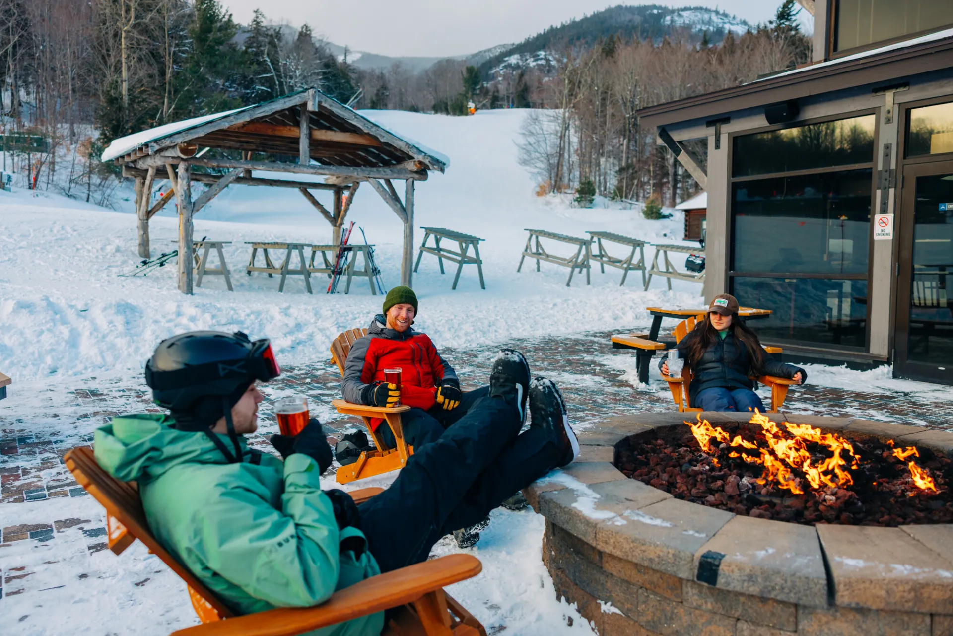 A group sitting by a fire at Whiteface Mountain.