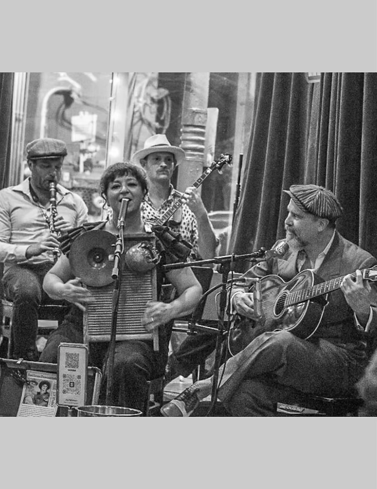 Black and white grainy photo of Bad Penny Pleasuremakers performing