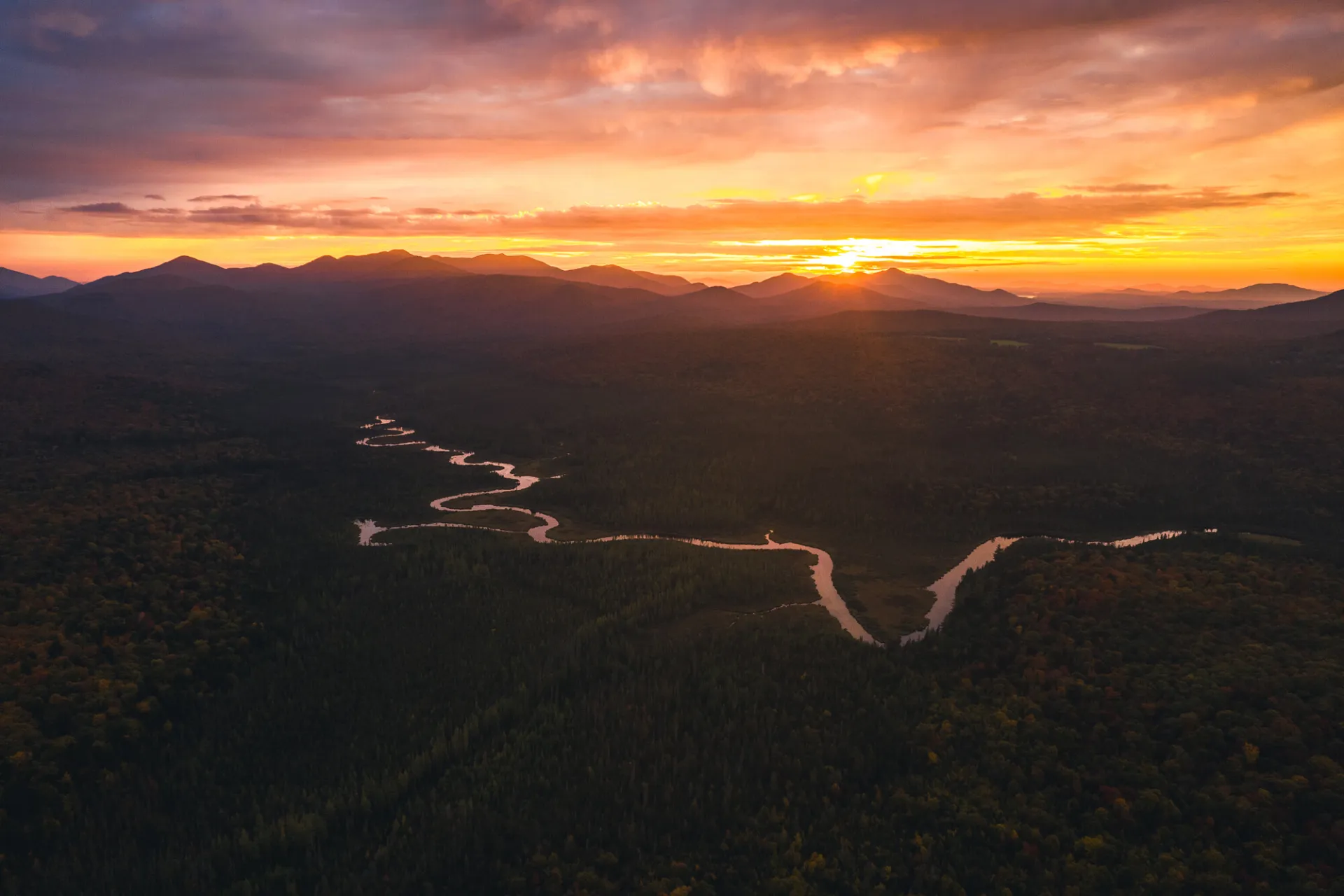 Aerial view of a winding river during sunset