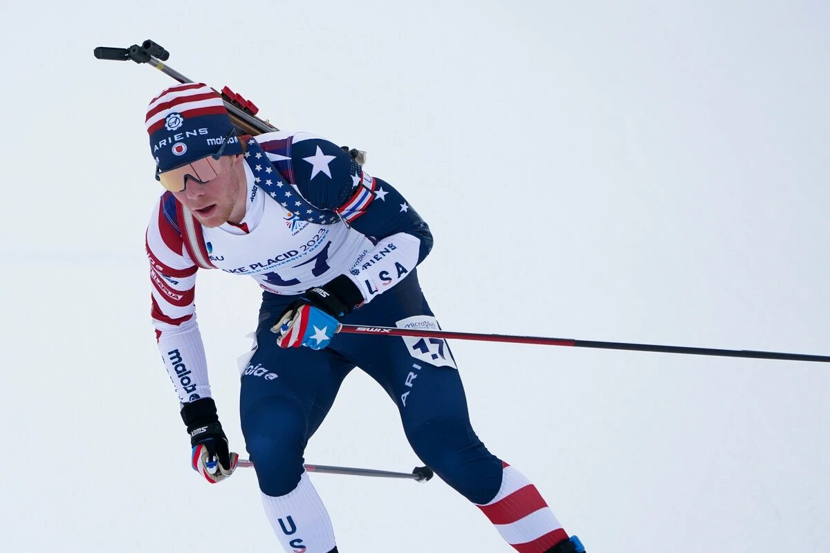 The image shows an athlete in a winter sports setting, wearing a patriotic outfit featuring the American flag. 