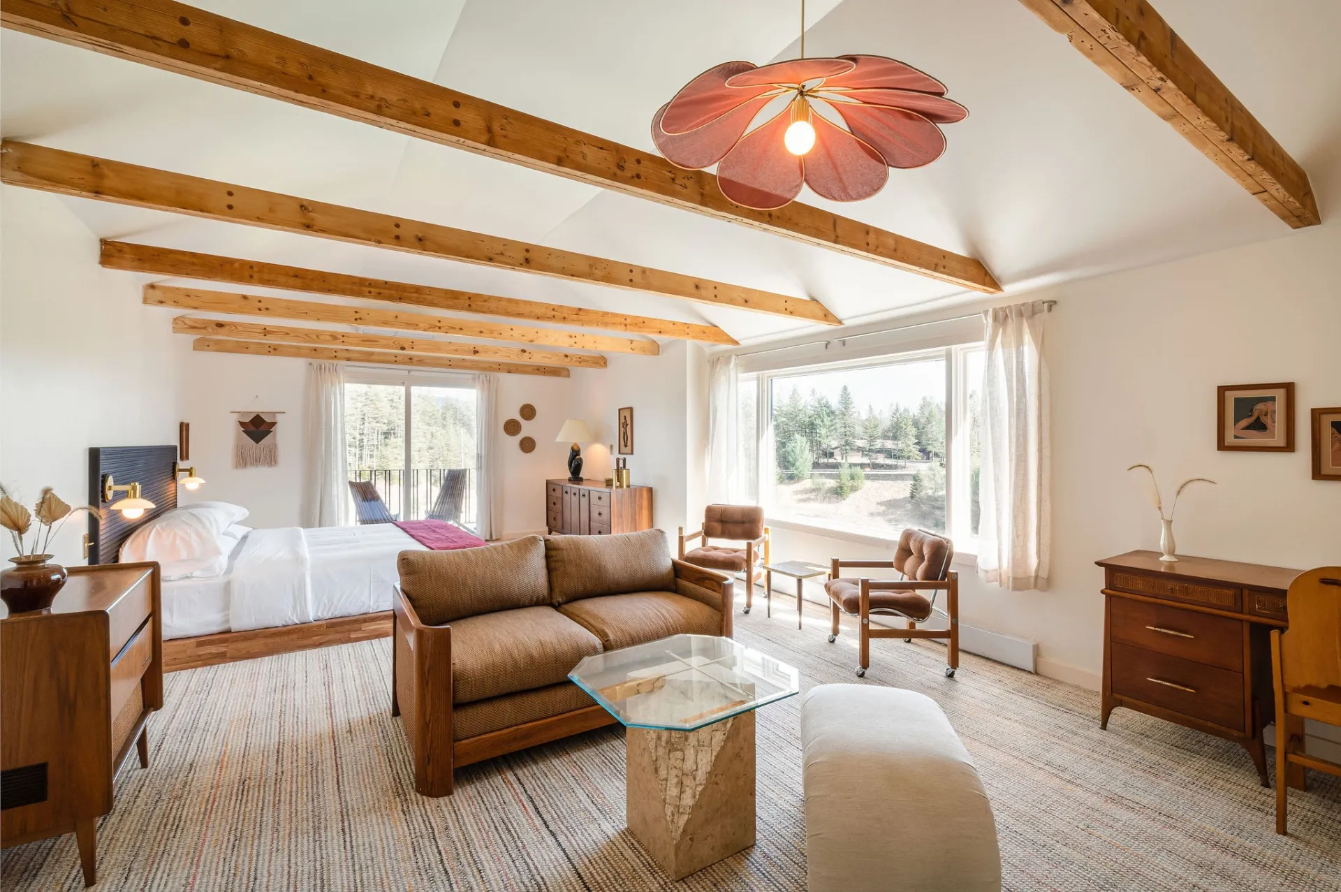 A well appointed room with high ceilings and a floral lamp
