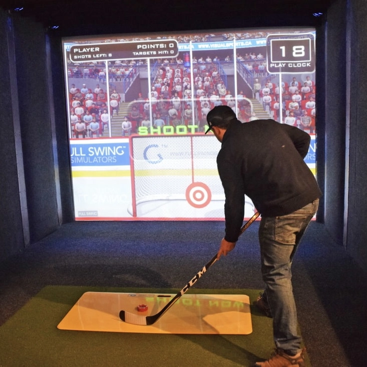 A man uses the simulator to practice his goal shots
