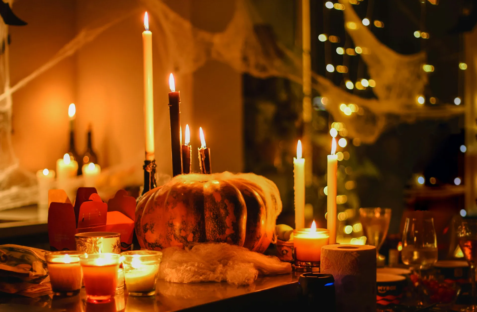 Pumpkins and candles on table