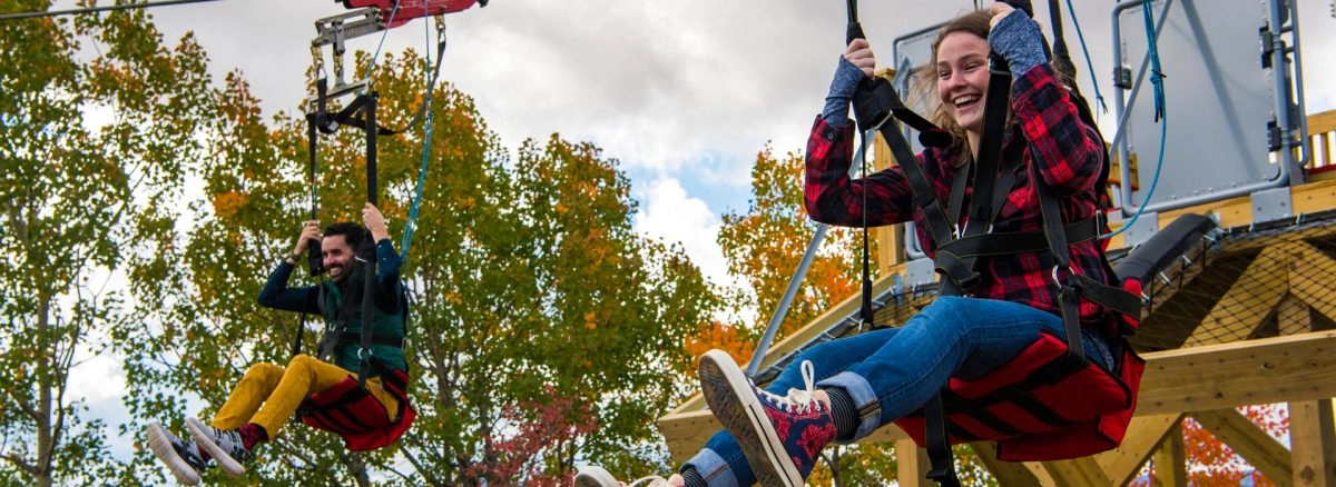 A couple smiles as they start the zipline