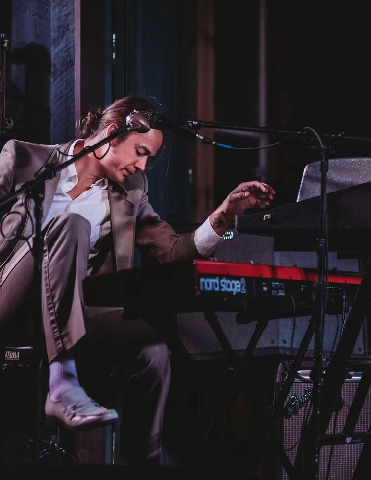 Charlie Millard Band members plays keyboard on stage in live performance