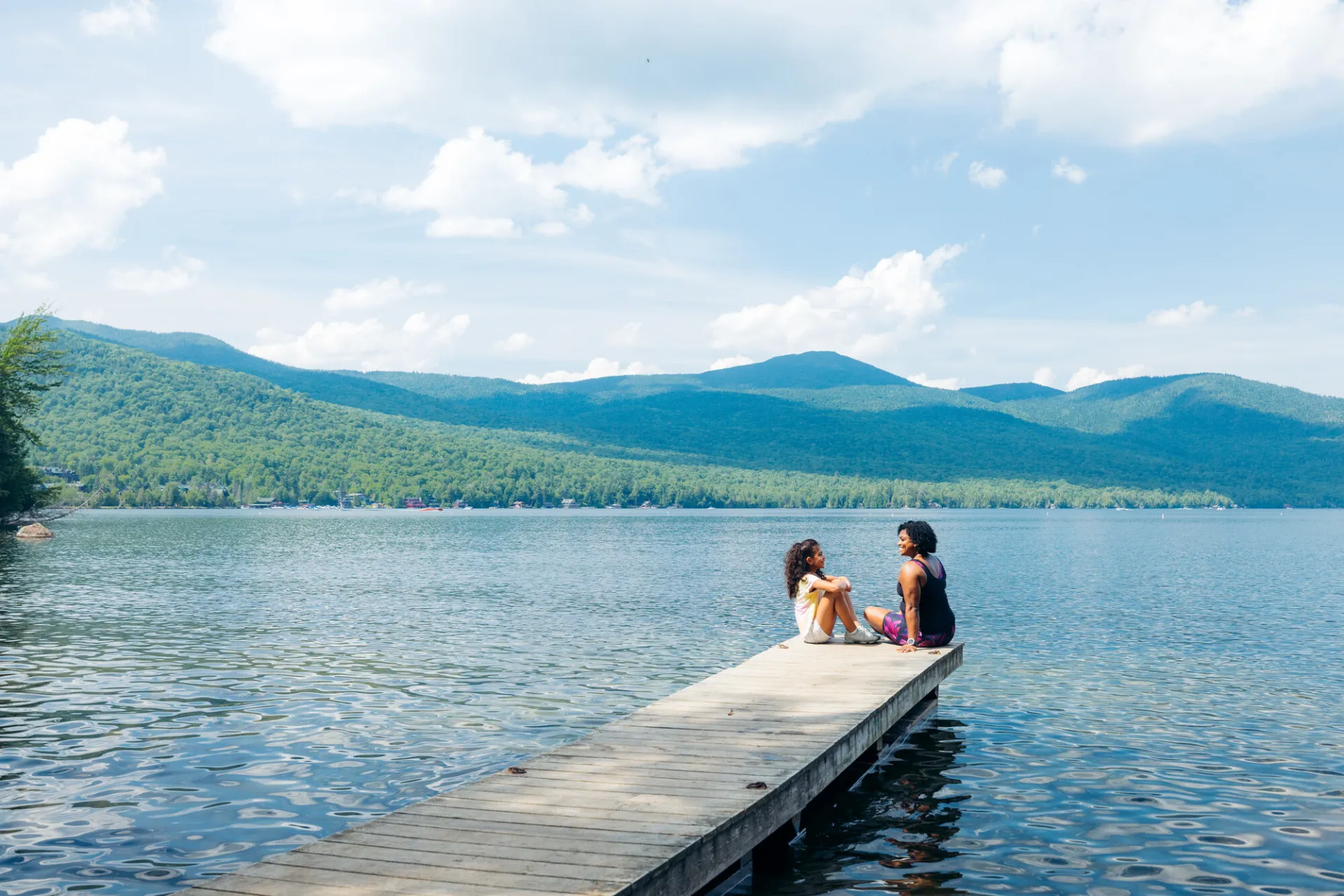 A mother and daughter on a dock in Lake Placid.