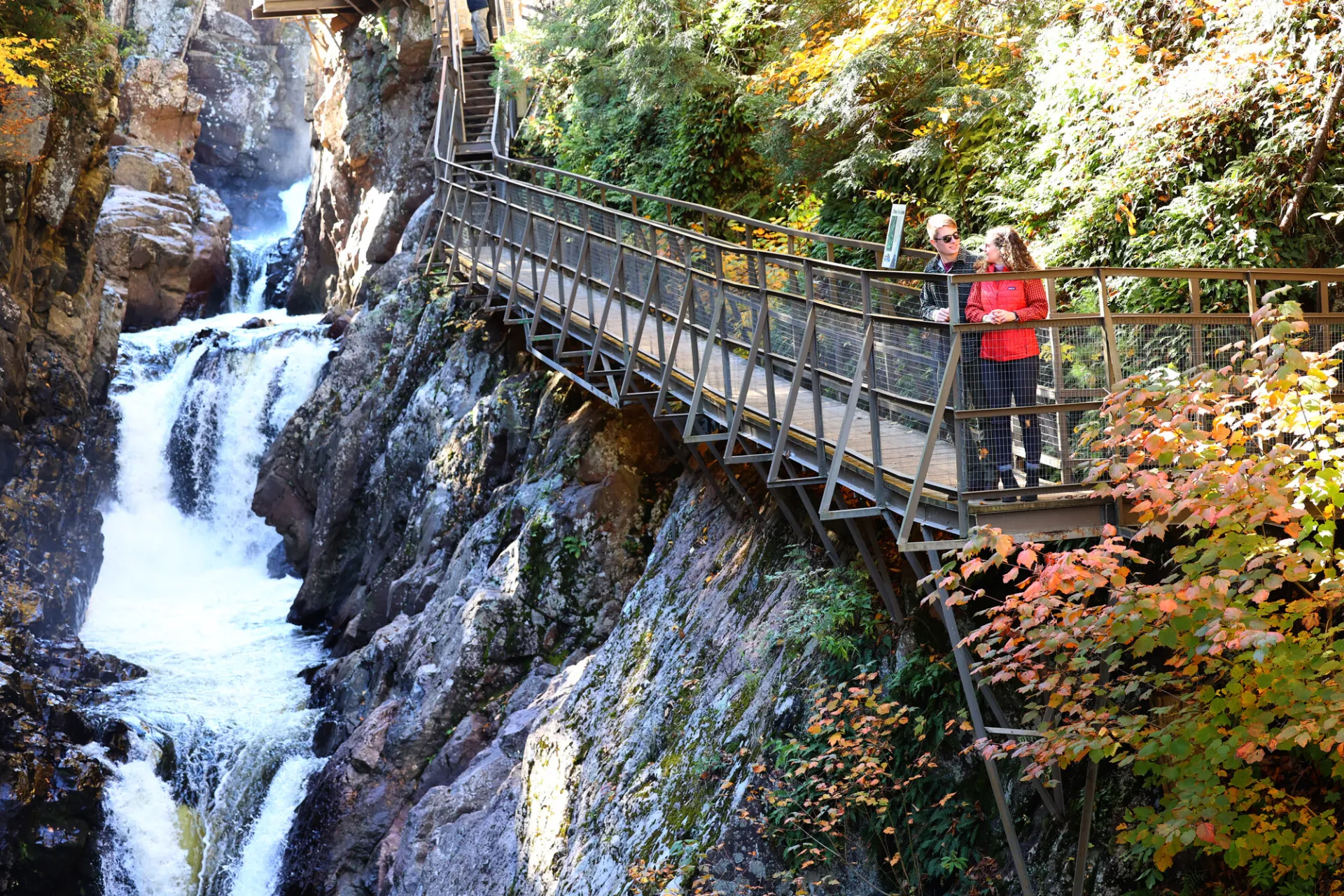 A couple walking at High Falls Gorge during the fall.