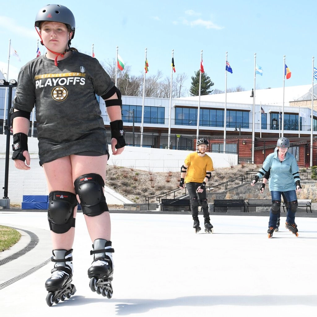 Kids in safety gear and roller blades enjoy the James C. Sheffield Speed Skating Oval
