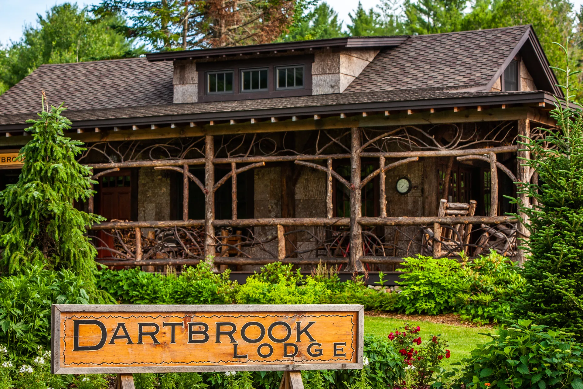 A large entry to a rustic building with a sign reading Dartbrook Lodge.