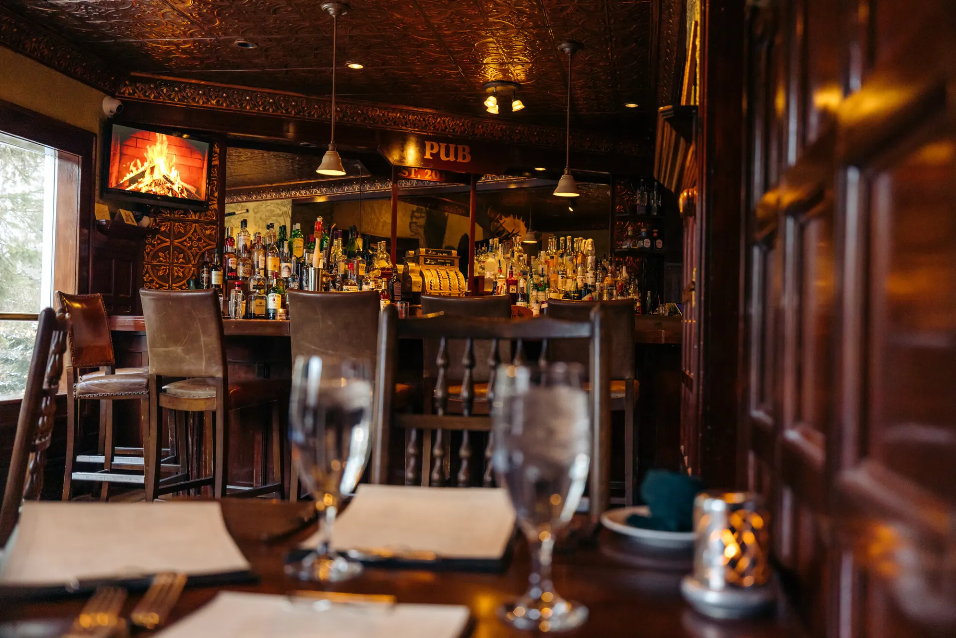 The Interlaken Inn bar area with set table with water glasses in foreground