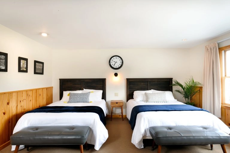 Two bed room option with white linens and blue accents
