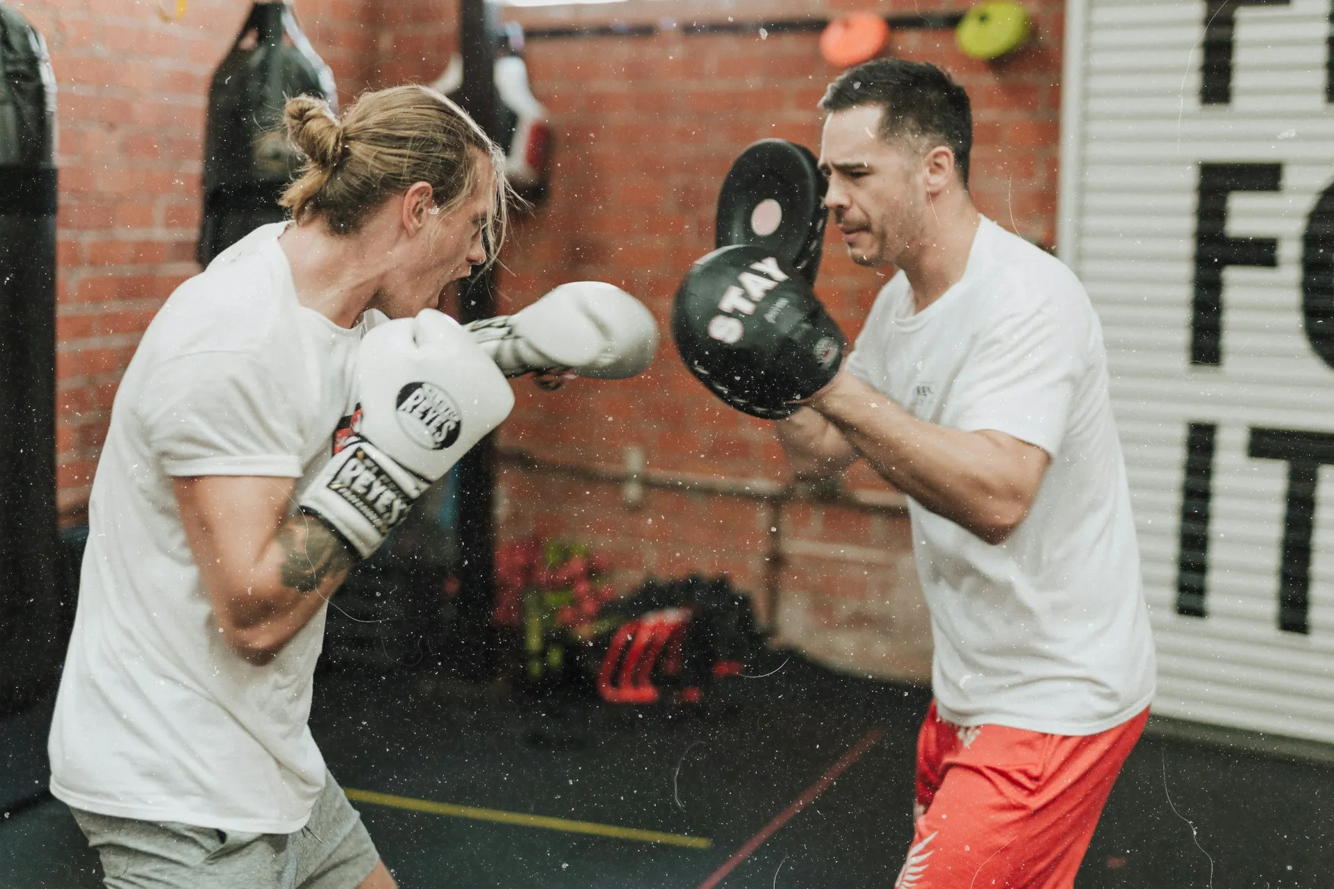 Two people sparring in a boxing ring.