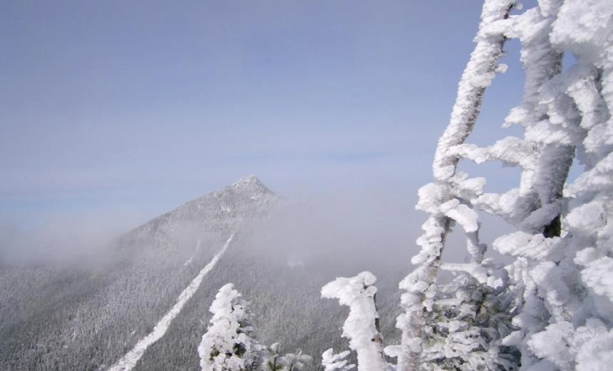 A winter view of a high mountain with a rock slide on it
