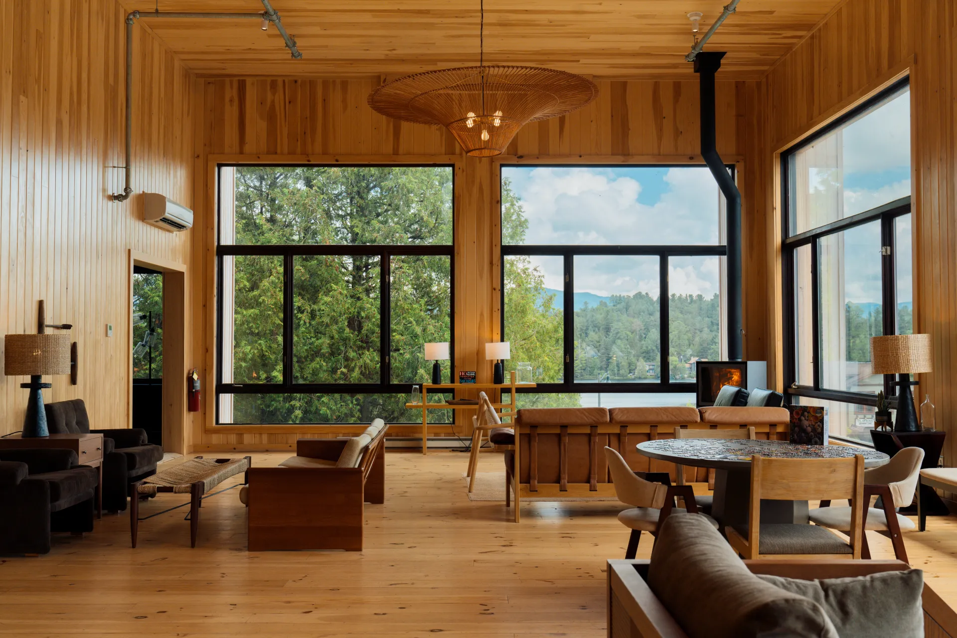 The fully wooden double height lobby with grand windows overlooking Mirror Lake with ample warm leather seating and fireplace