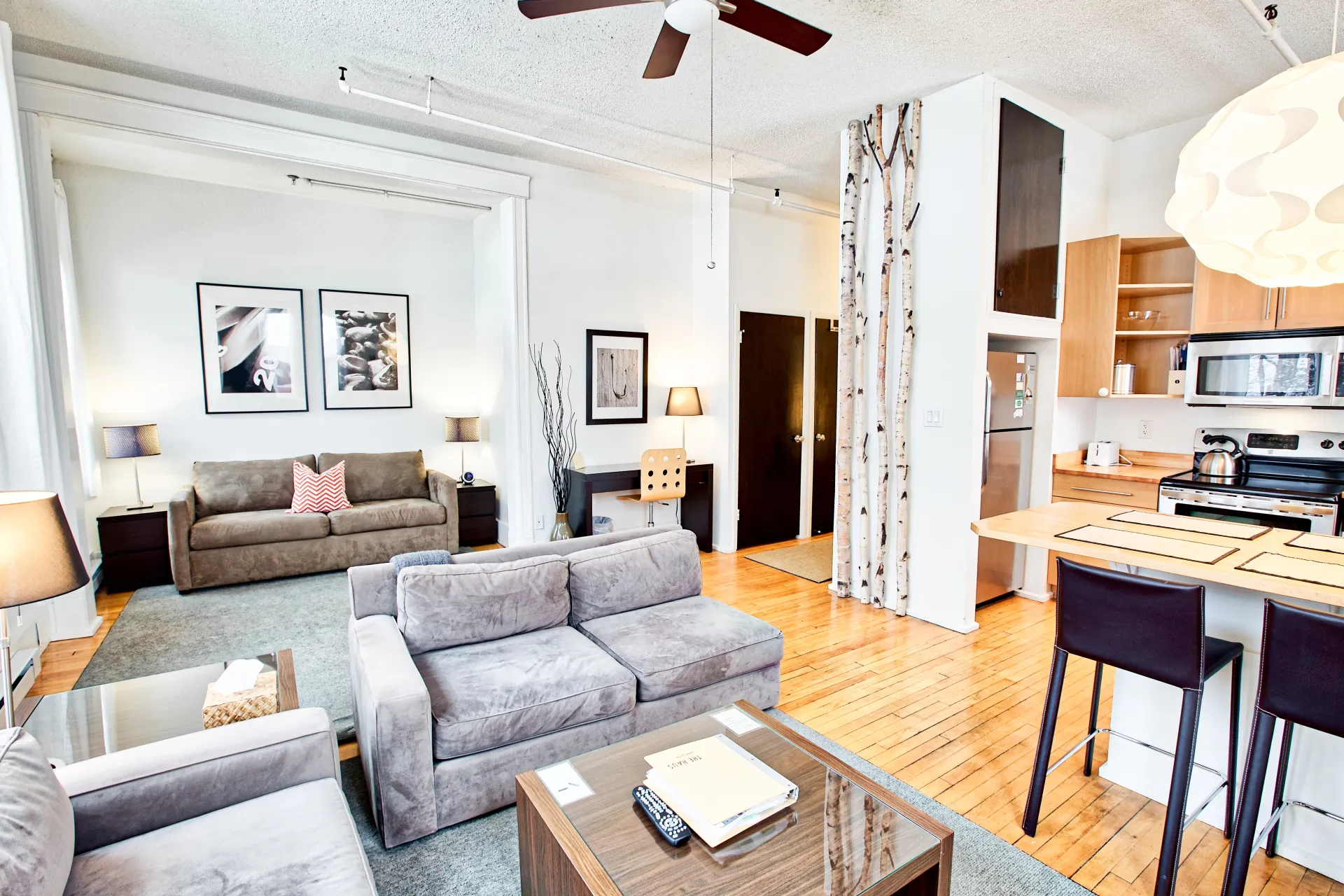 The many bright sitting areas with birch art accent wall.