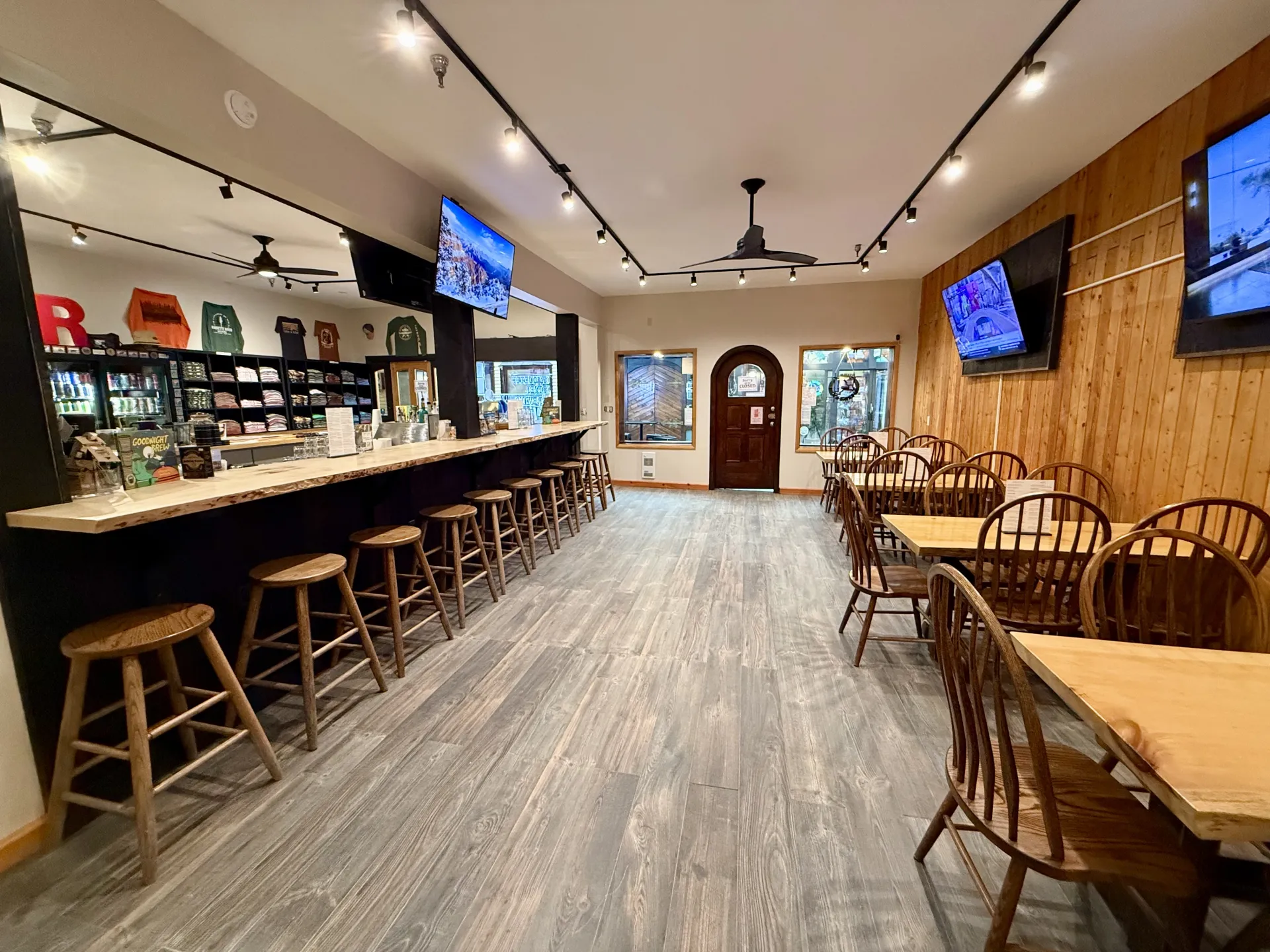Large space with dining tables and chairs opposite the bar area at Raquette River Brewing Taproom.