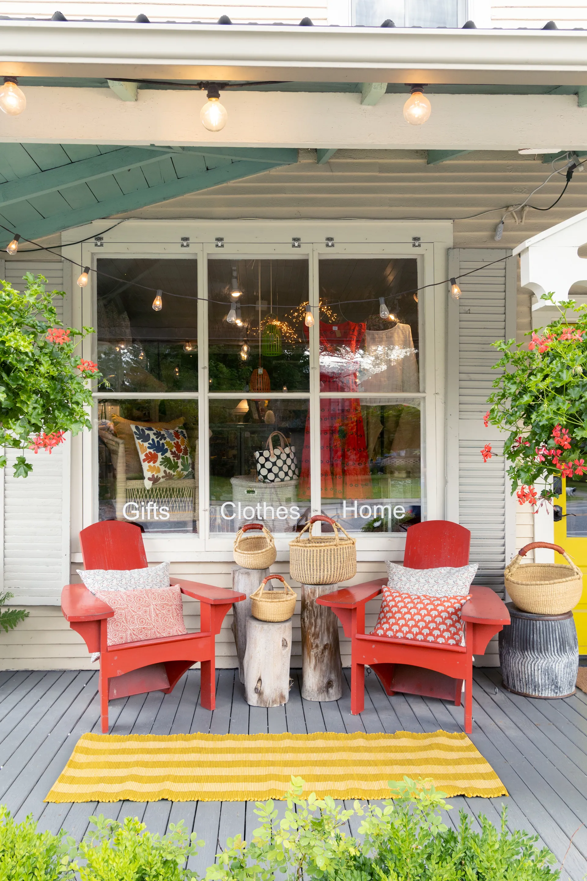 The exterior of The Birch Store with red adirondack style chairs with matching pillows