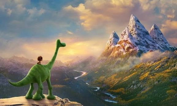 Screenshot from The Good Dinosaur movie with boy riding a green dinosaur looking over a valley at tall mountains