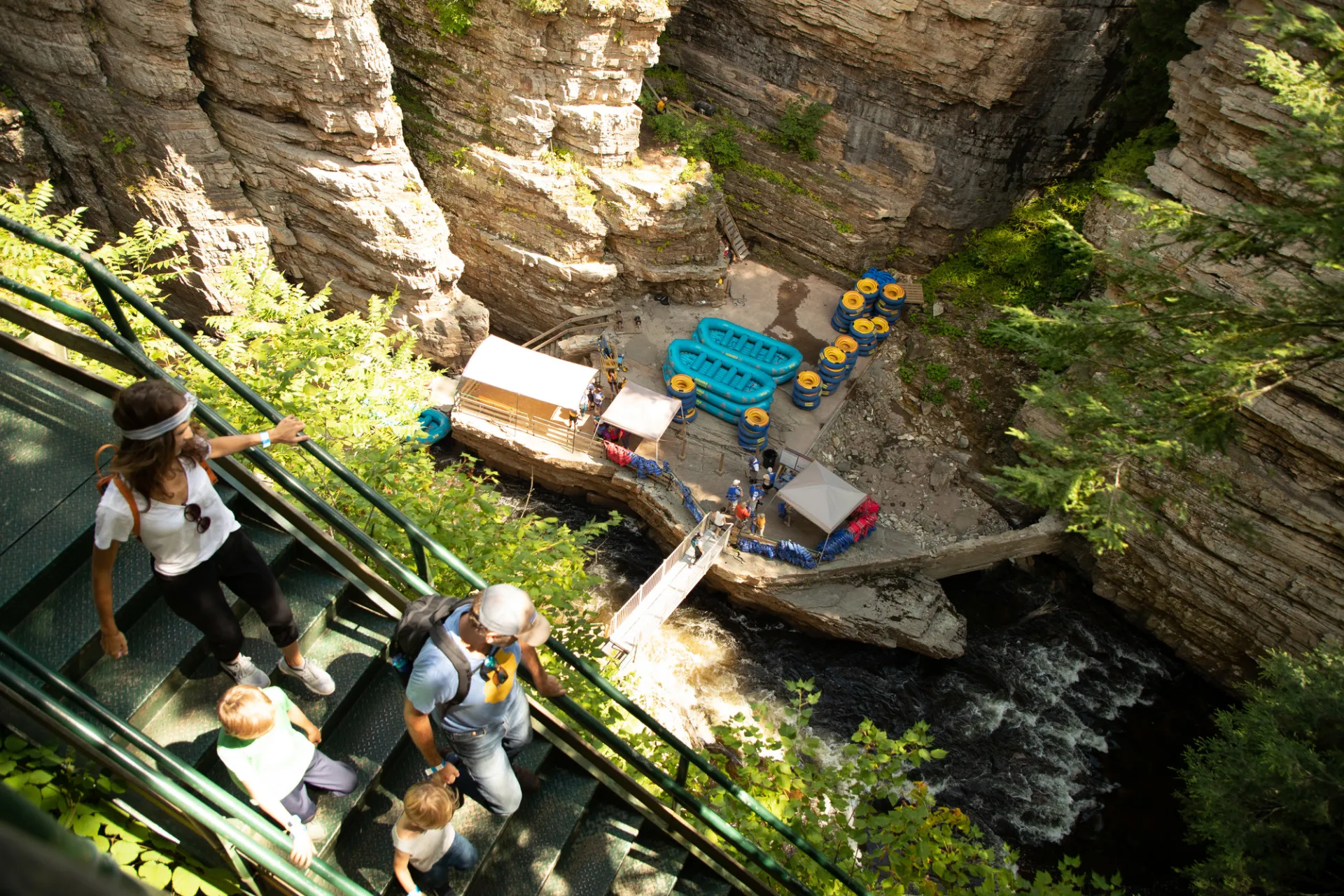 A family walking down the stairs to the landing area for rafting at Ausable Chasm.