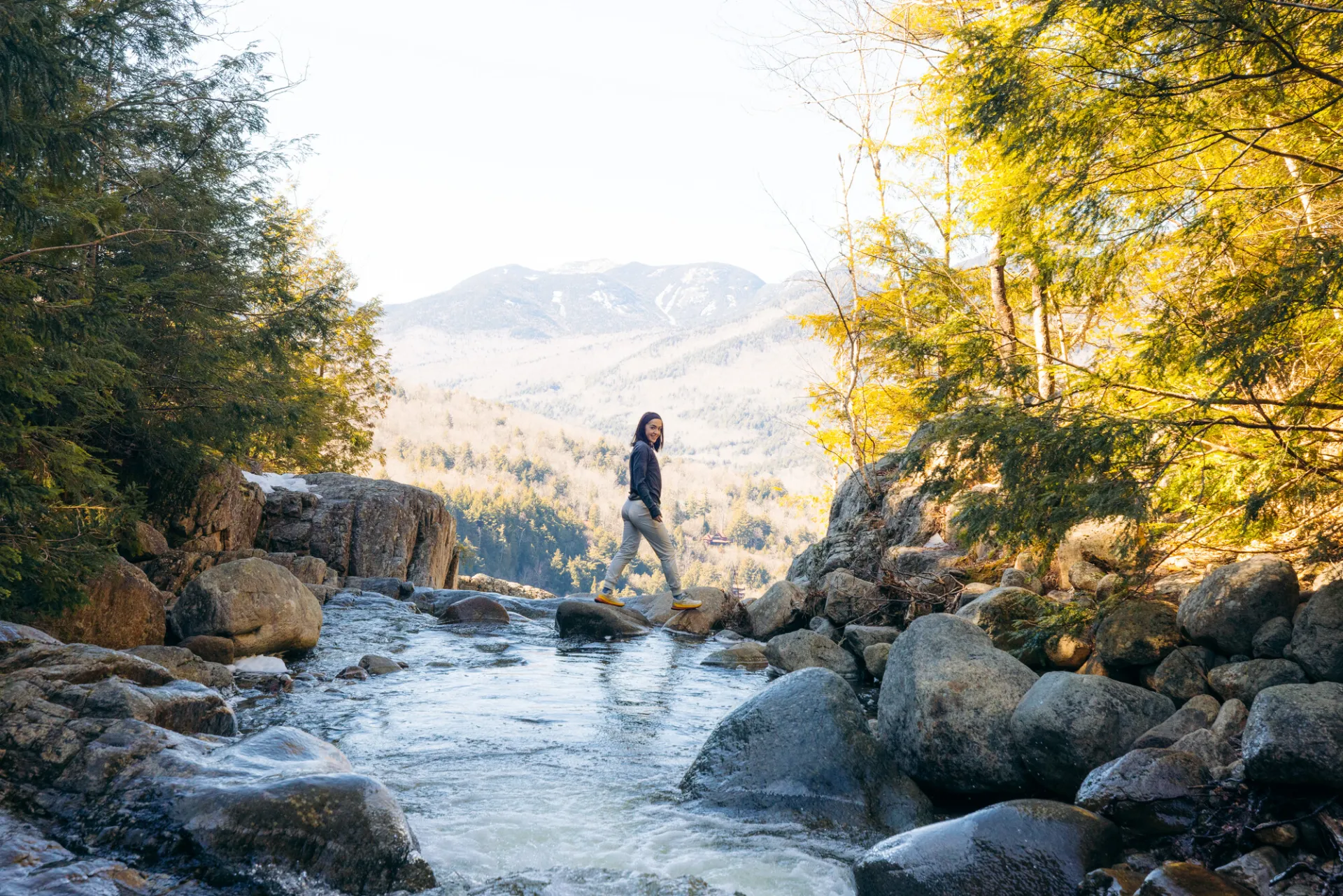 A hiker at the top of a waterfall