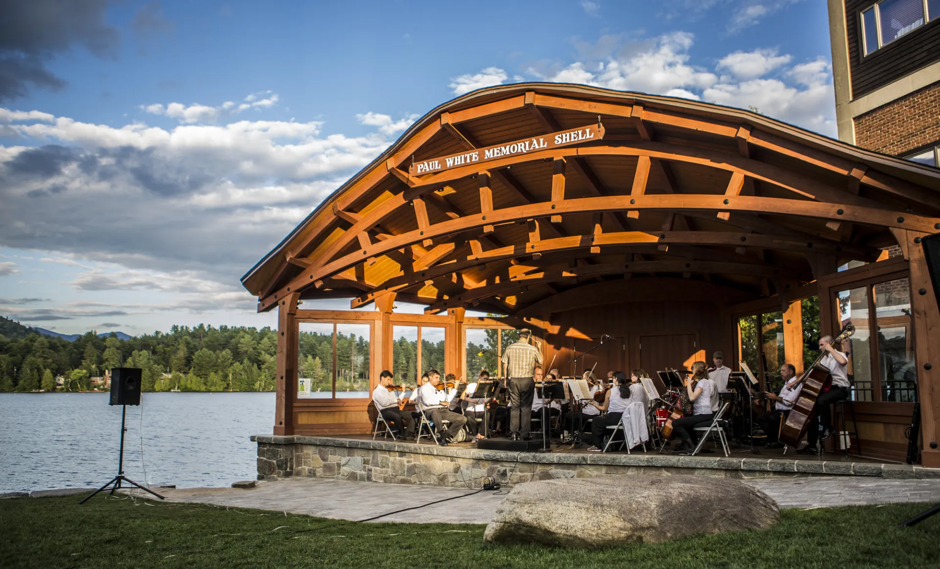 Sinfonietta playing in a lakeside bandshell on a summer day