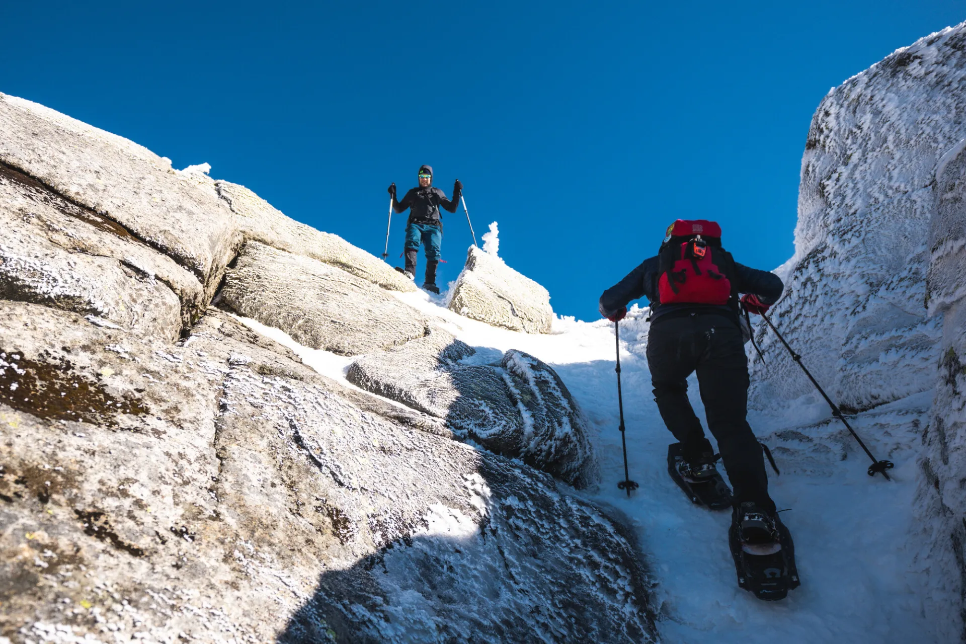 Snowshoers going up a steep rocky area