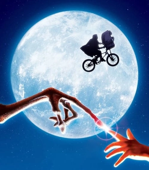 A graphic from the movie E.T. the extra-terrestrial, showing the moon as a backdrop to Elliott riding his bicycle with E.T. in the basket